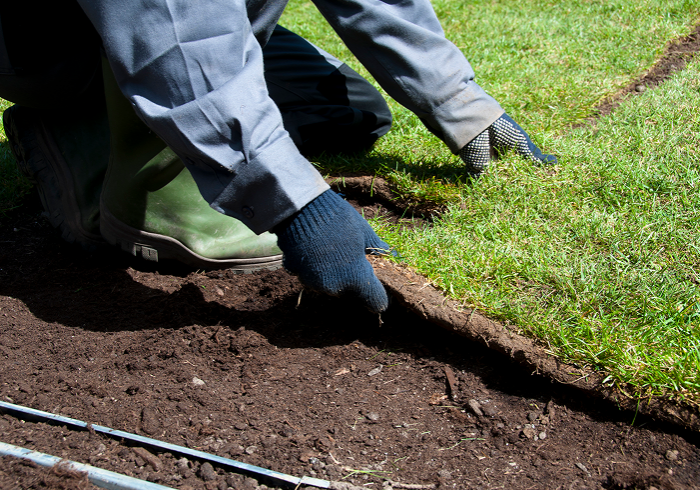 Worker positioning grass patches